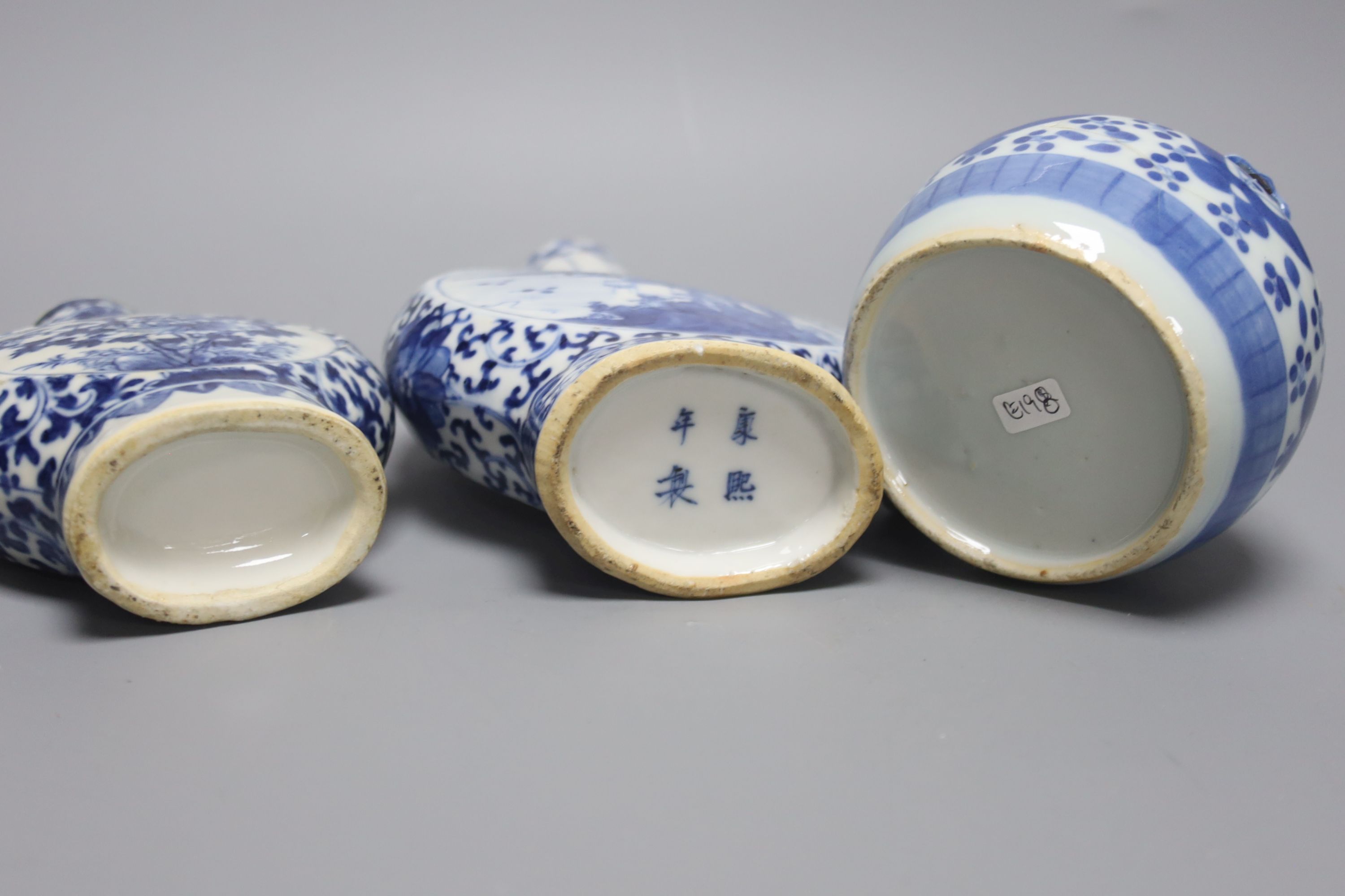 Two 19th century Chinese blue and white moon flasks and a teapot, tallest 21cm